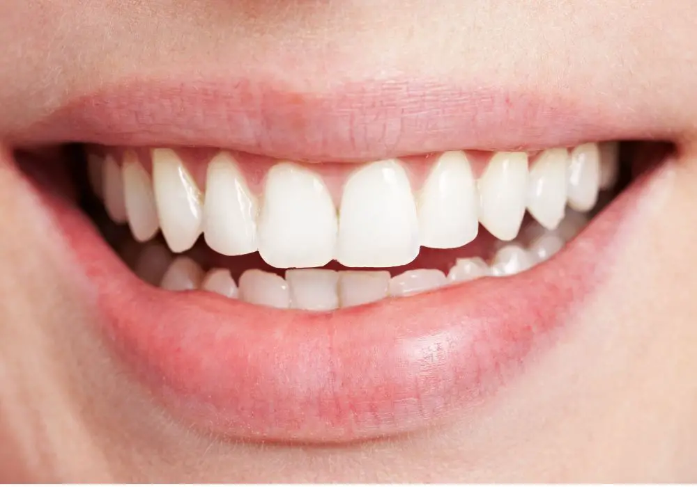 What causes enamel to wear away?