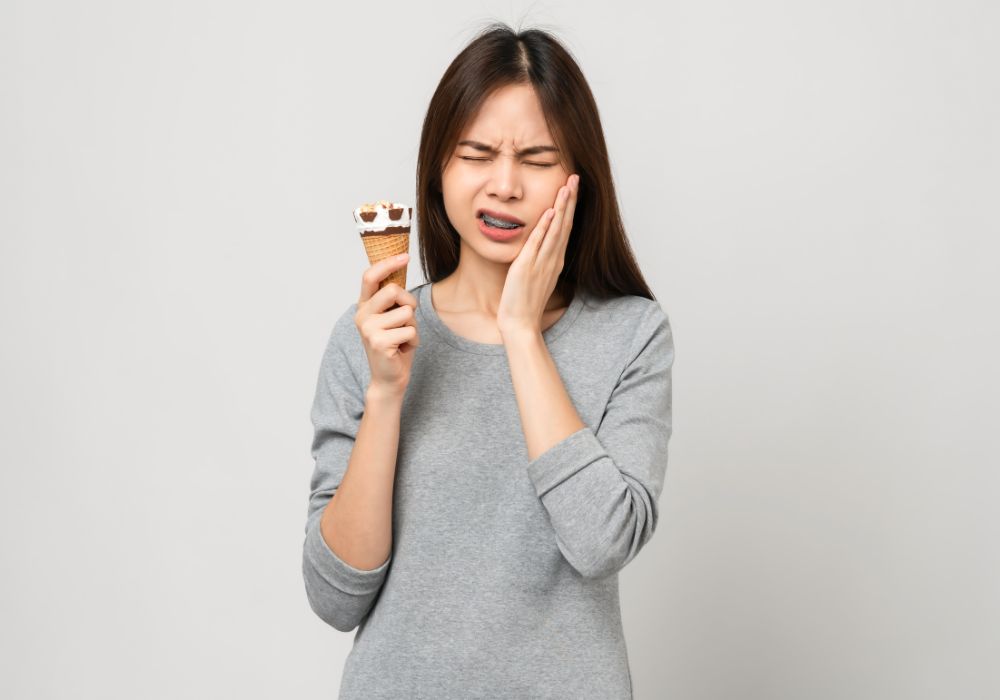 What causes recurring or chronic tooth sensitivity?