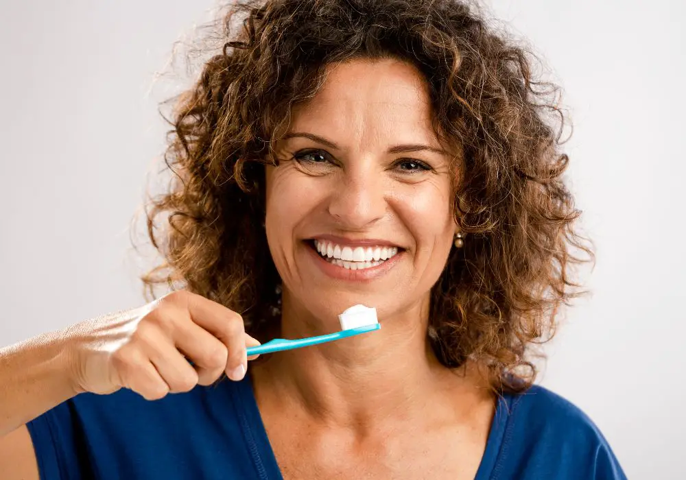 When should I see a dentist for brushing discomfort?